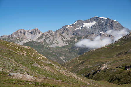 A summer mountain hiker on the summits in front of glaciersの写真素材