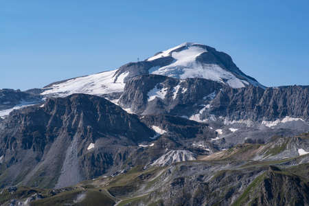 A summer mountain hiker on the summits in front of glaciers