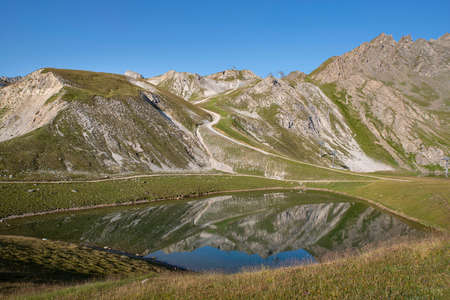 Mountain landscape with a lake in summer in the French Alpsの写真素材