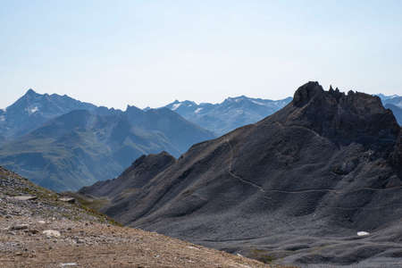 Mountain landscape with a rock arch in summer in the French Alps in Tignesの写真素材