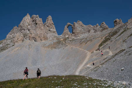 Mountain landscape with a rock arch in summer in the French Alps in Tignesの写真素材