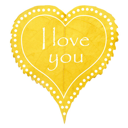Heart formed by a yellow tree leaf decorated with "I love you" written in Englishの写真素材