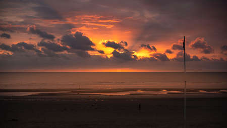 Sunset on a beach by the seaの写真素材