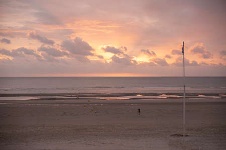 Sunset on a beach by the seaの写真素材