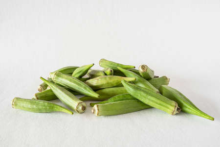 Small pile of green okra on a white backgroundの写真素材