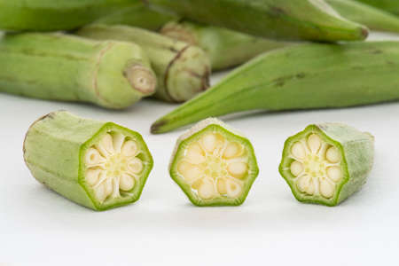 Small pile of green okra on a white backgroundの写真素材