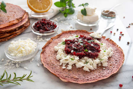 Close-up of pink pancakes with beetroot and feta, and green pancakes with spinachの写真素材