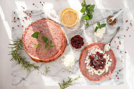 Close-up of pink pancakes with beetroot and feta, and green pancakes with spinachの写真素材