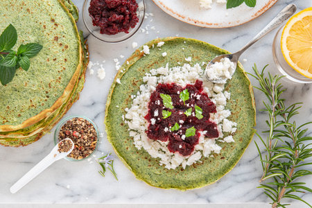 Close-up of pink pancakes with beetroot and feta, and green pancakes with spinachの写真素材