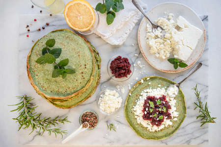 Close-up of pink pancakes with beetroot and feta, and green pancakes with spinachの写真素材