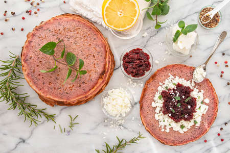 Close-up of pink pancakes with beetroot and feta, and green pancakes with spinachの写真素材