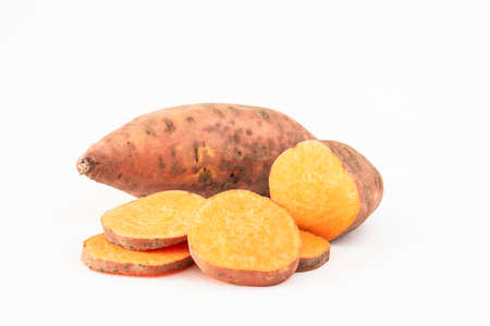 Close-up of whole and sliced sweet potatoesの写真素材
