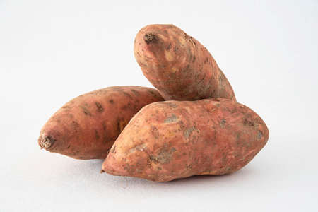 Close-up of whole and sliced sweet potatoesの写真素材