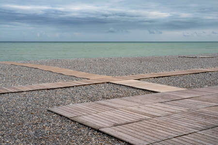 Beach hut and pebble beach in the town of Dieppe in Normandyの写真素材