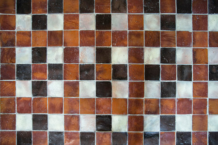 Texture of an old medieval red, black and white tileの写真素材