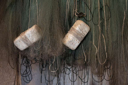 Close-up of a green fishing net with floats