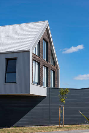 Modern house with a fence and a treeの写真素材