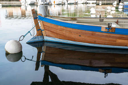 A wooden boat moored in a harbor on Lake Genevaの写真素材