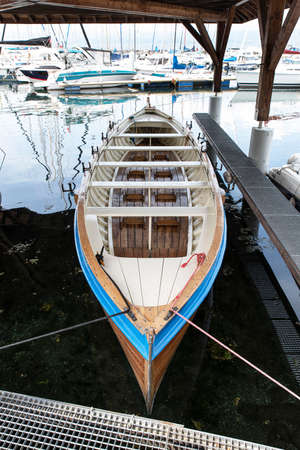 A wooden boat moored in a harbor on Lake Genevaの写真素材