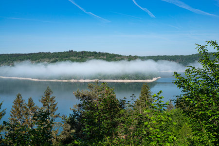 Landscape of the Jura in France with a lake, clouds above and the forestの写真素材