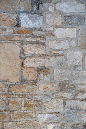 Irregular and brown stone wall textureの写真素材