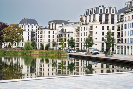 Modern architecture of apartment buildings in a residential area on a lakeの写真素材