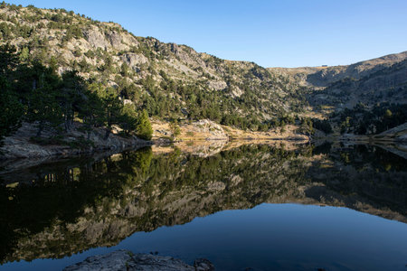 Mountain lake with a reflection of the mountain of Chamrousse in the Alps in Franceの写真素材