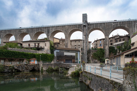 Old stone aqueduct in the town of Saint Nazaire en Royansの写真素材