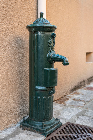 Old green hydrant with a tapの写真素材