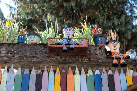 Original house and garden fence in the shape of colored pencils with flower pots in the shape of charactersの写真素材