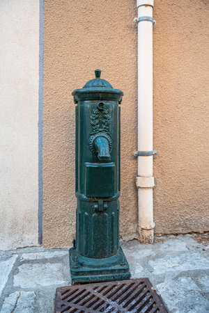 Old green hydrant with a tapの写真素材