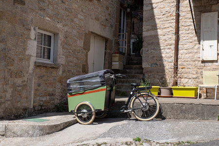 green cargo bike parked in townの写真素材