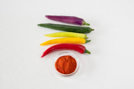 Close-up of different colored chillies and ground chilli powderの写真素材