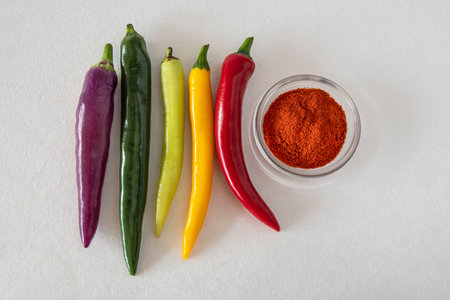 Close-up of different colored chillies and ground chilli powderの写真素材