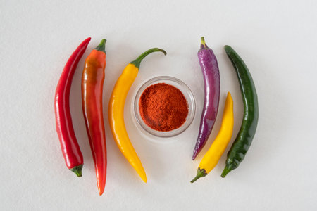 Close-up of different colored chillies and ground chilli powderの写真素材