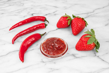 Close-up of strawberries and homemade jam with red peppersの写真素材