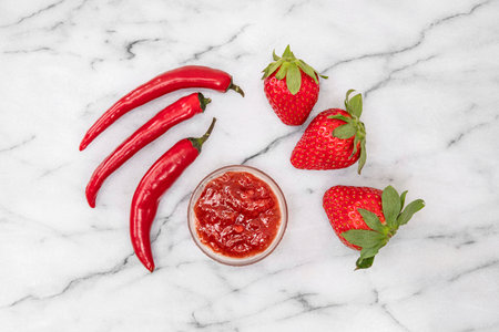 Close-up of strawberries and homemade jam with red peppersの写真素材