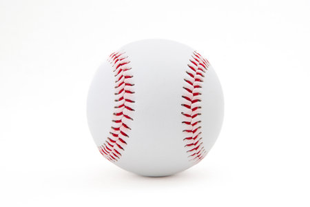 Close-up of a white baseball with red stitching on a white backgroundの写真素材