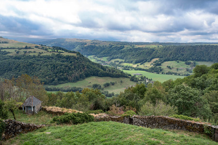 Country landscape in Auvergne, France with mountains, forests and fields for agricultureの写真素材