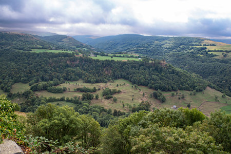Country landscape in Auvergne, France with mountains, forests and fields for agricultureの写真素材