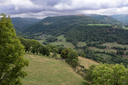Country landscape in Auvergne, France with mountains, forests and fields for agricultureの写真素材
