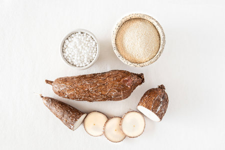 Close-up of a cassava root on Tapioca and cassava white background with tapioca pearlsの写真素材