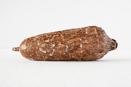 Close-up of a cassava root against a white backgroundの写真素材