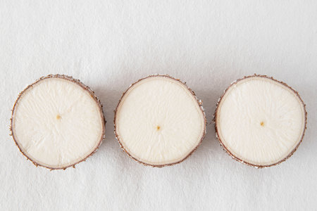 Close-up of a cassava root against a white backgroundの写真素材