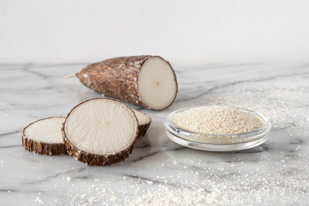Cassava root and flour on a white backgroundの写真素材