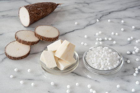 Cassava root on white background with tapioca pearlsの写真素材