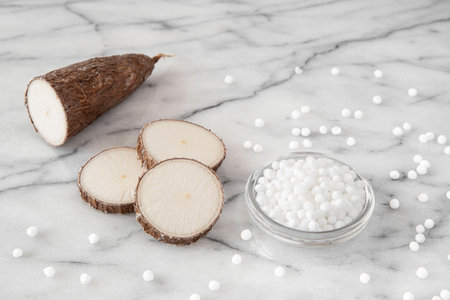 Cassava root on white background with tapioca pearlsの写真素材