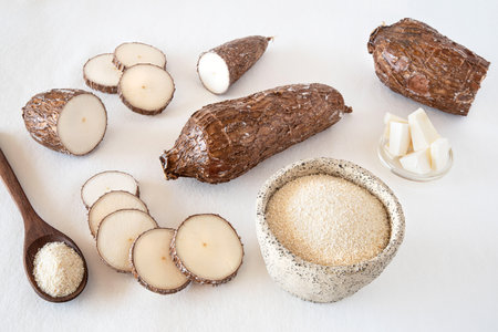 Cassava root and flour on a white backgroundの写真素材