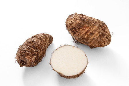 raw whole and cut taro or eddo tuber rootの写真素材