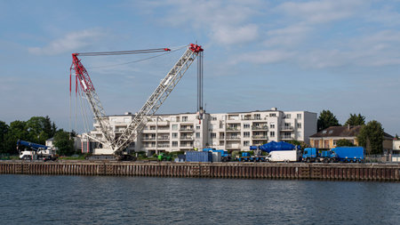 Large crane in front of a residential buildingの写真素材